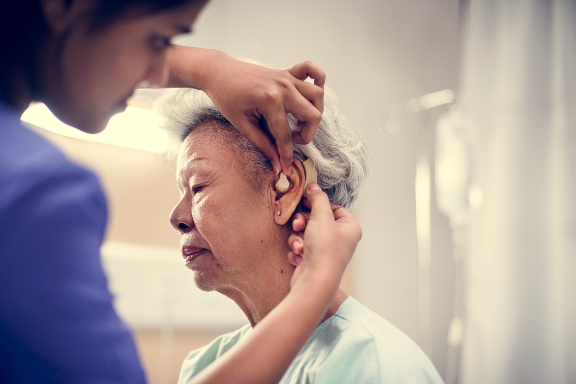 An elderly woman with hearing aid