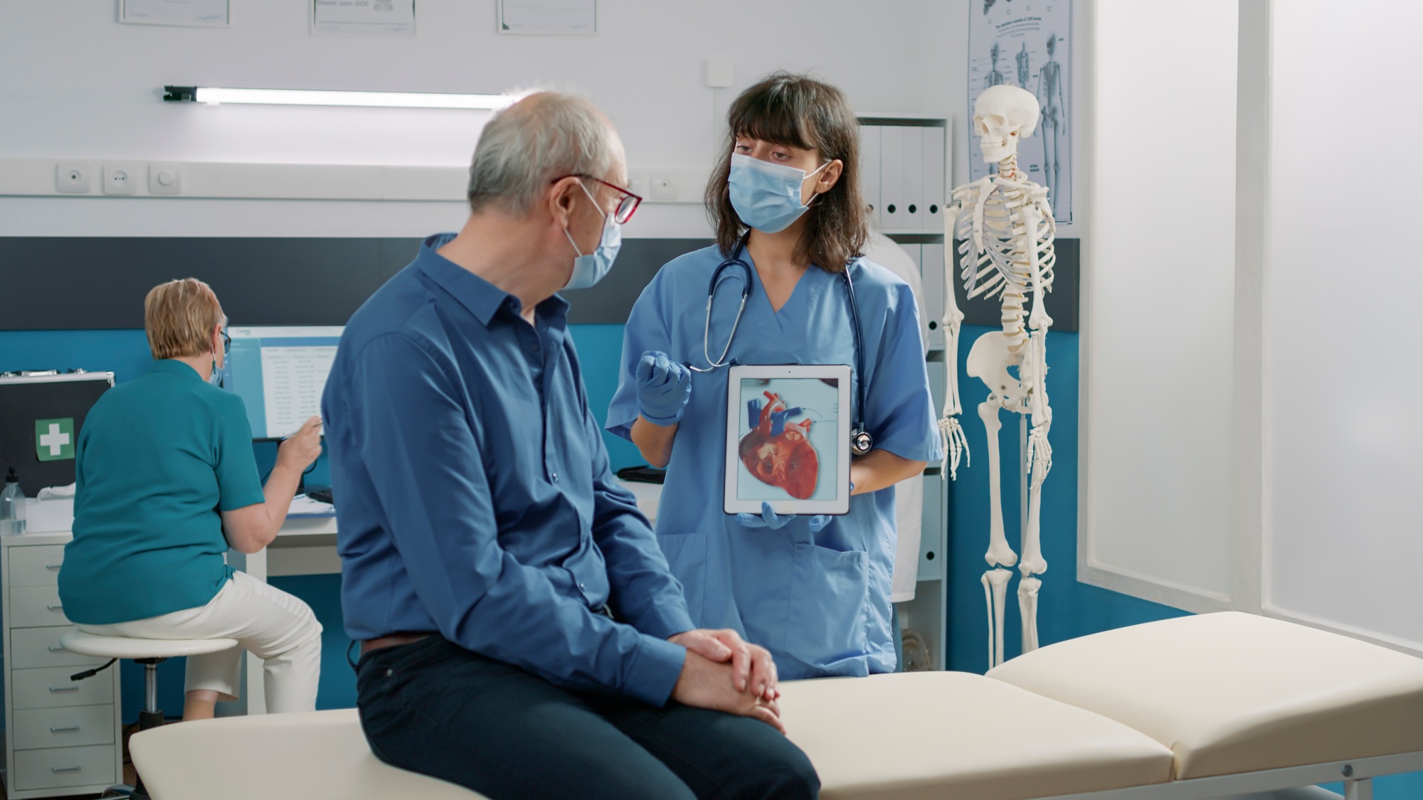 Female assistant holding tablet with cardiovascular system