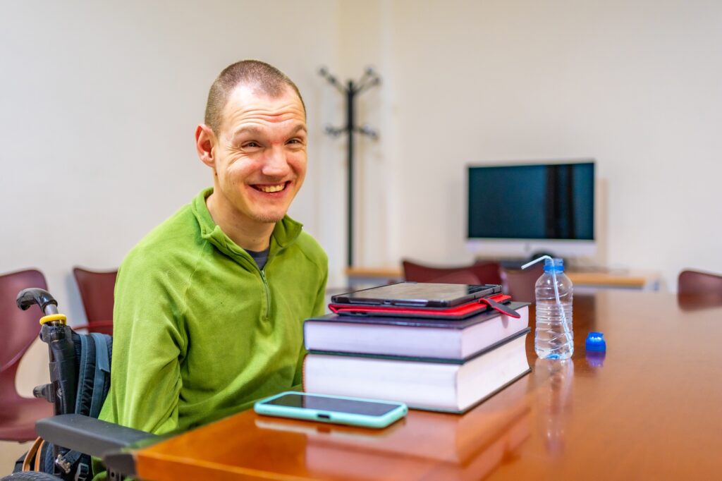 Man with disability sitting in wheelchair in the university