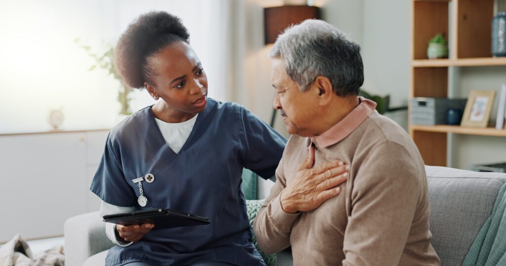 Senior, man and caregiver with tablet for consultation with coughing, chest pain and pneumonia symp